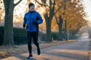 Middle-aged recreational runner beginning a run on a cold fall morning