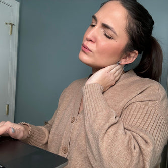Woman managing neck and shoulder tension with specialized Neck & Shoulder Relief by FORTHiQ